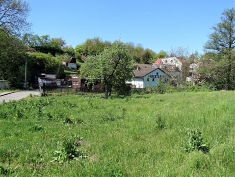 Pohled od silnice k&nbsp;potoku